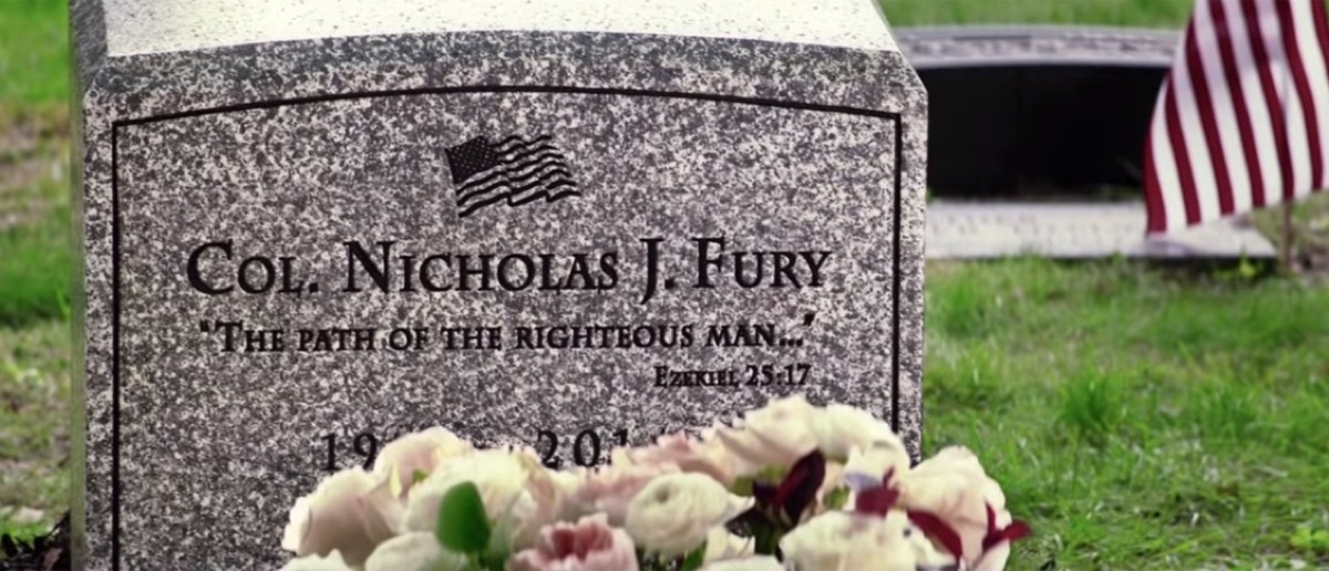 a tombstone with flowers in front of it