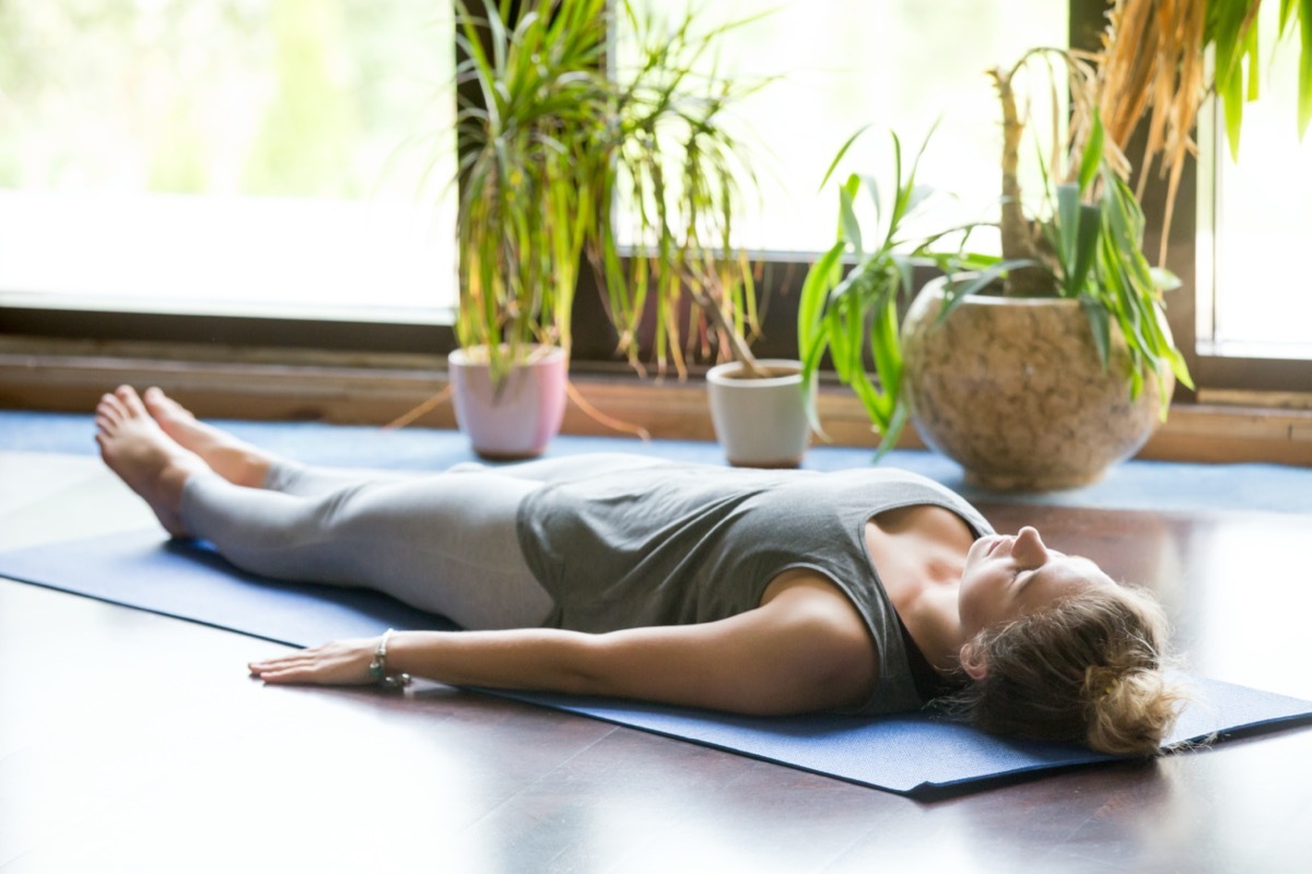 Woman doing corpse pose, yoga