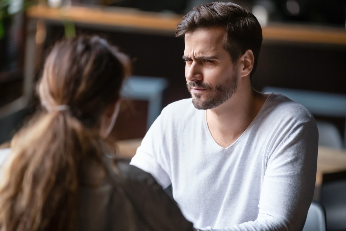 dissatisfied man looking at woman