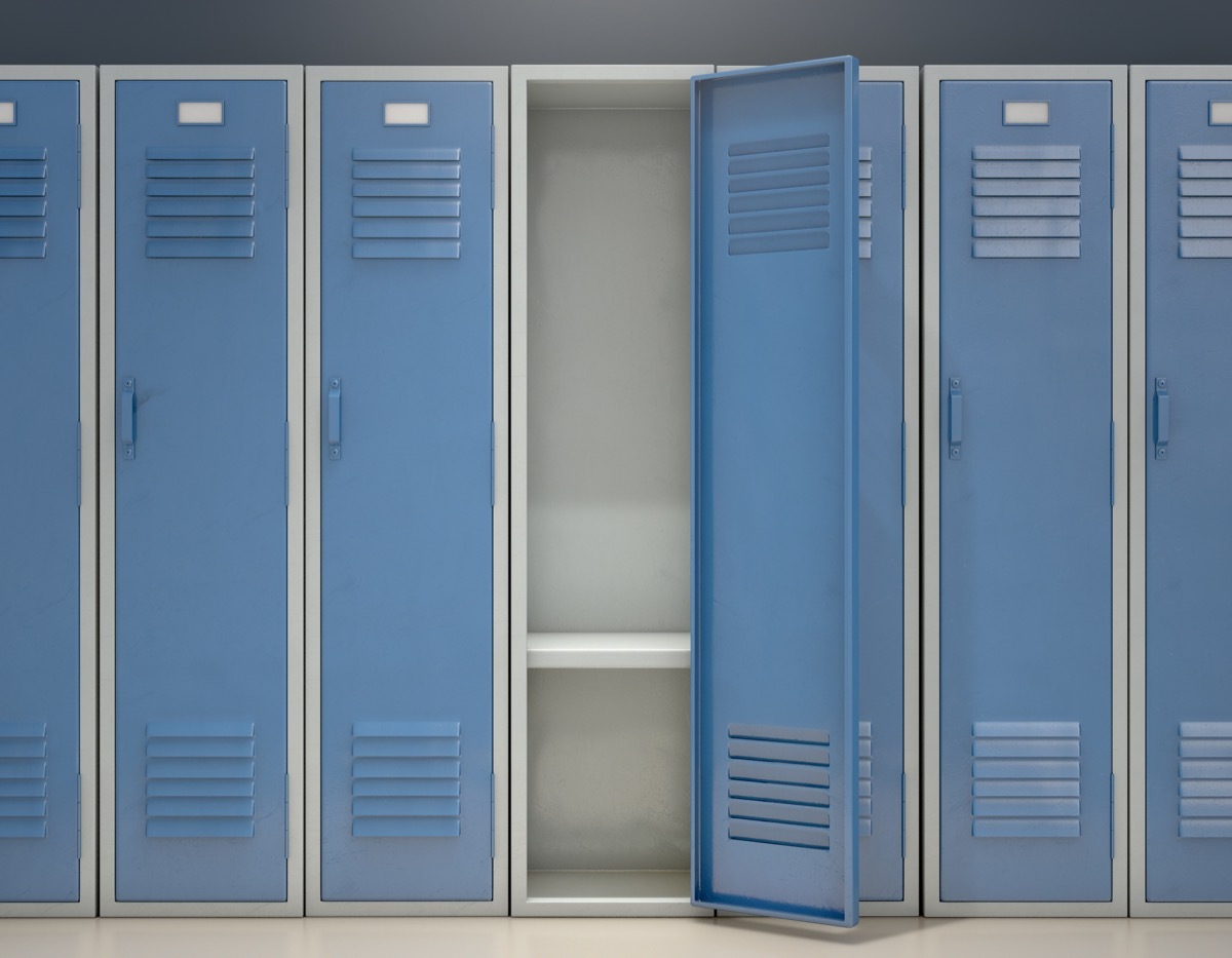 A row of blue metal school lockers with one open door revealing that it is empty