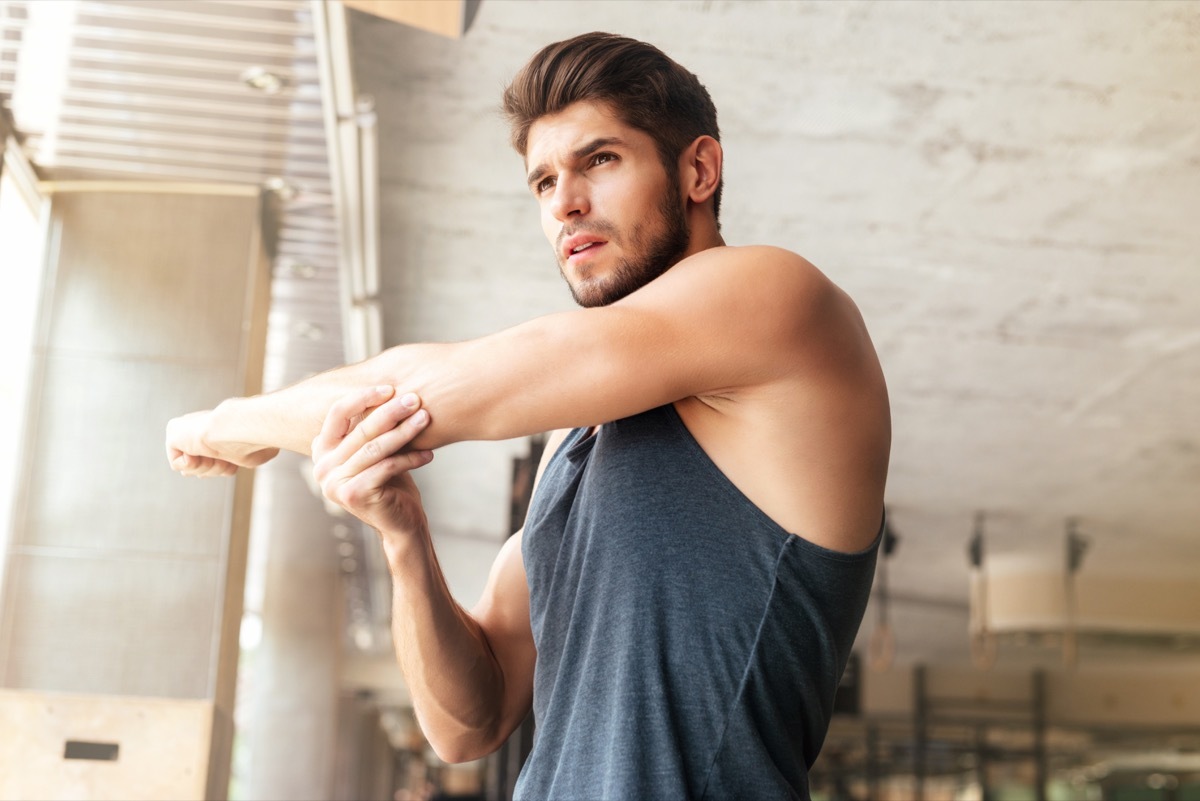 Man stretching in gym