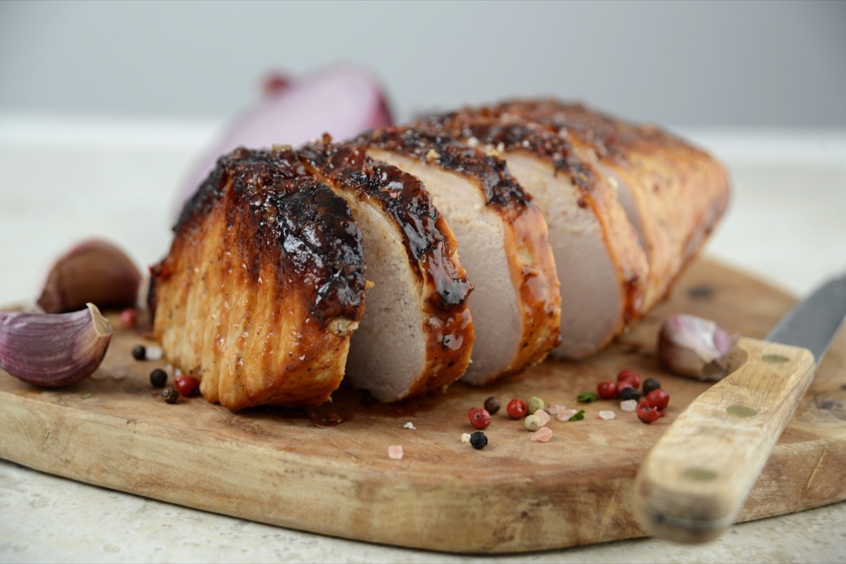 sliced pork loin on wooden cutting board