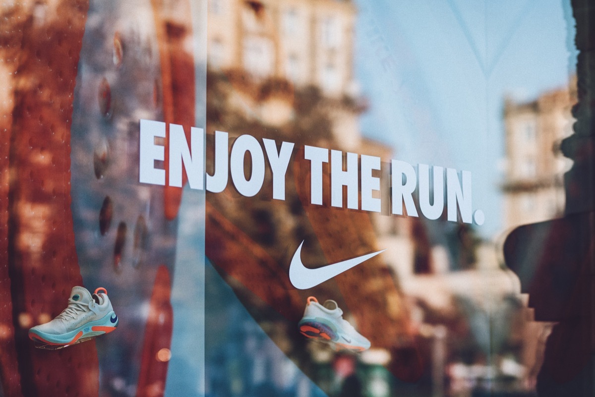 Nike logo brend sign on city street. Signboard of Nike logo on store, shop, mall, boutique. Kiev, Ukraine - September 02, 2019.