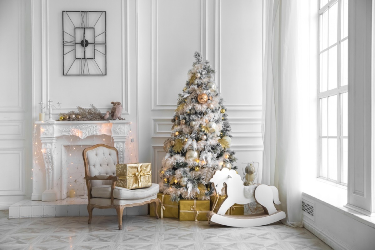 living room decorated in silver and gold for christmas