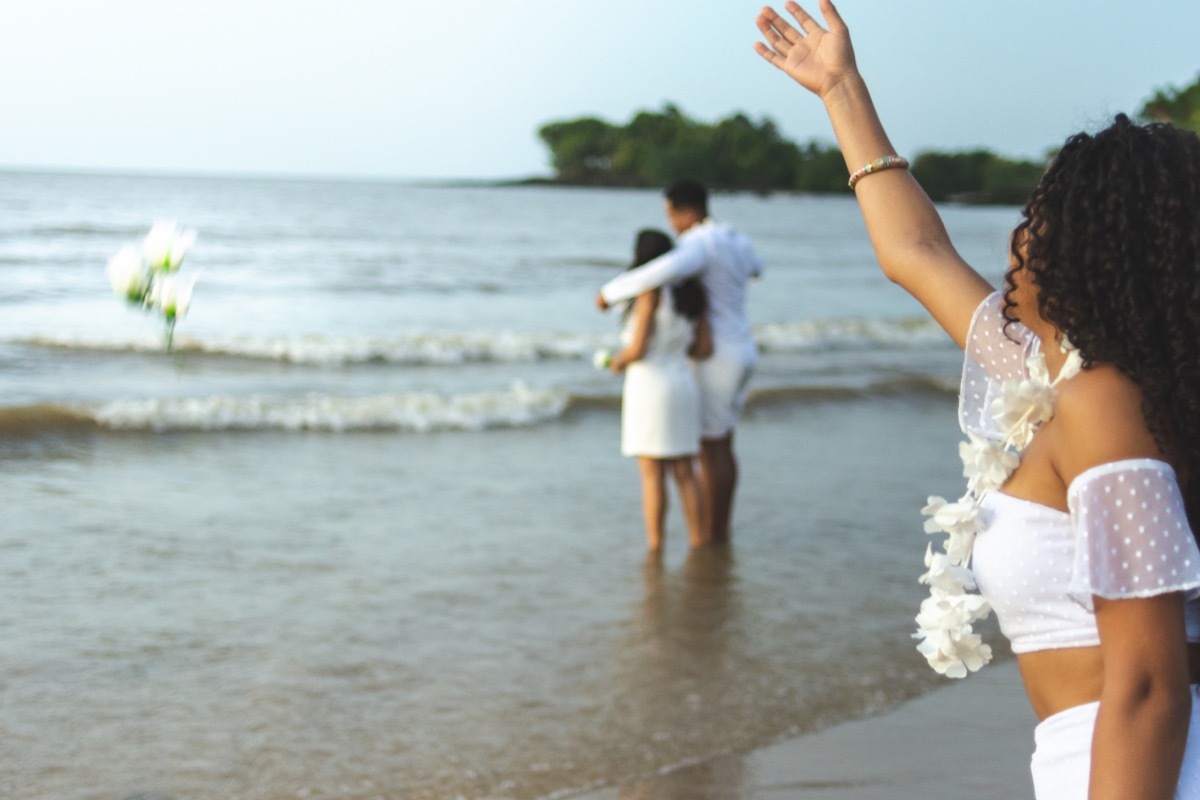 brazilian new years throwing white flowers into the ocean