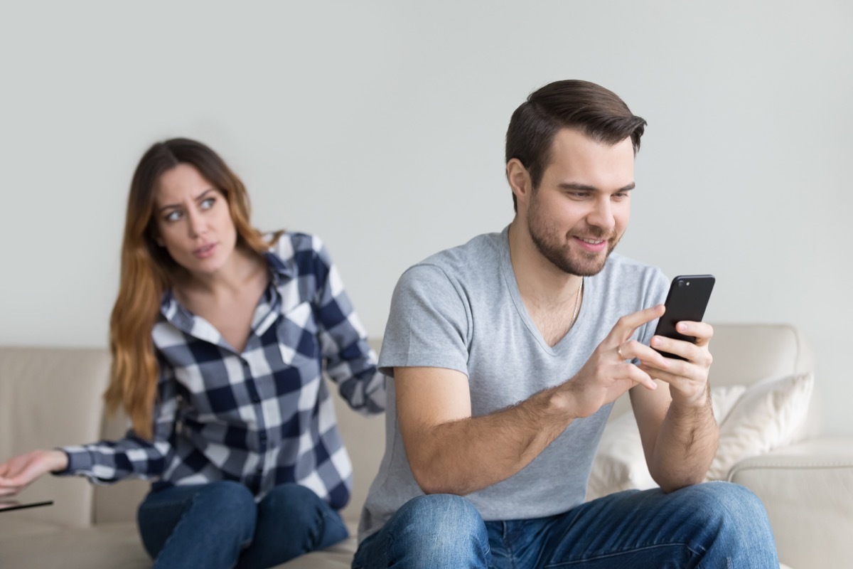 Man ignoring his wife because he's too distracted by his phone