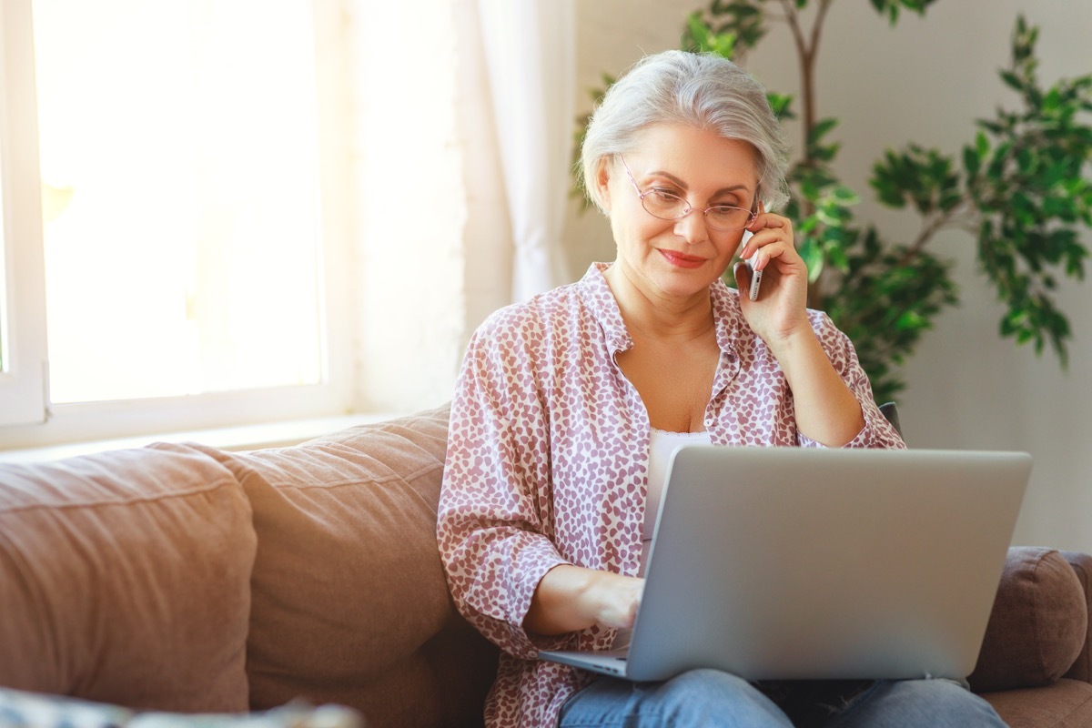 Older woman on laptop and phone call