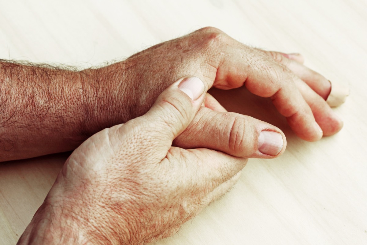 An elderly man has pain in his fingers and hands