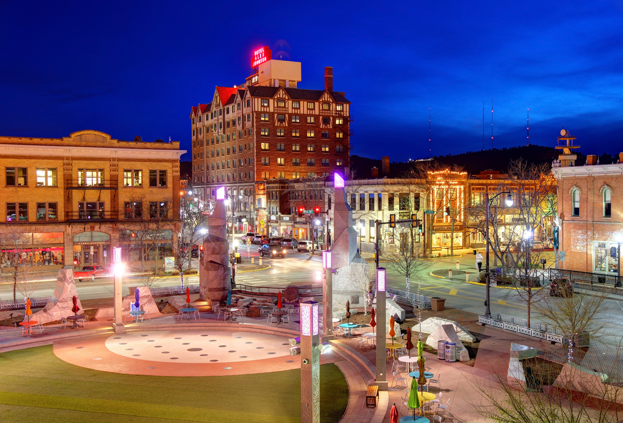 A view of Rapid City, South Dakota at night, with a park in the foreground.