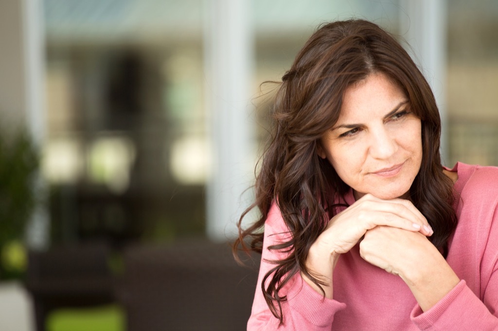 woman looking sad outdoors, worst things about an empty nest