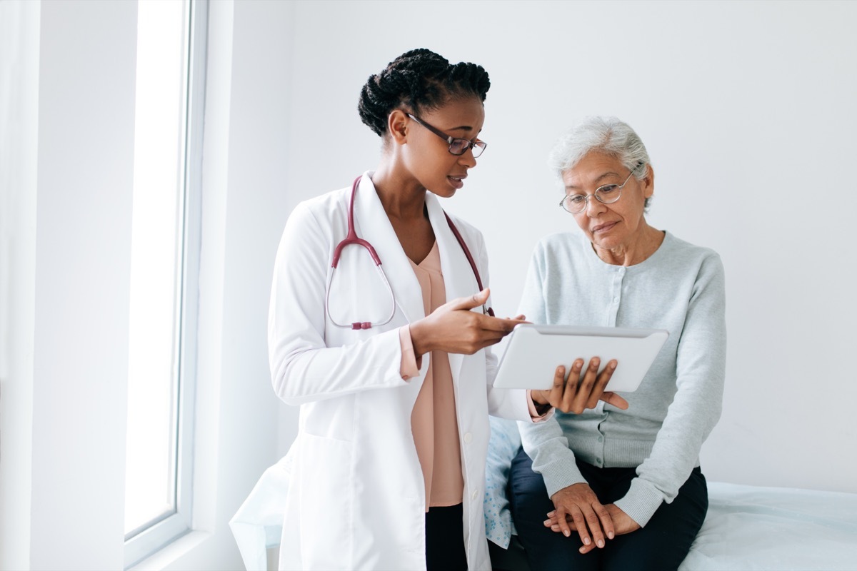 woman talking to young female doctor in glasses