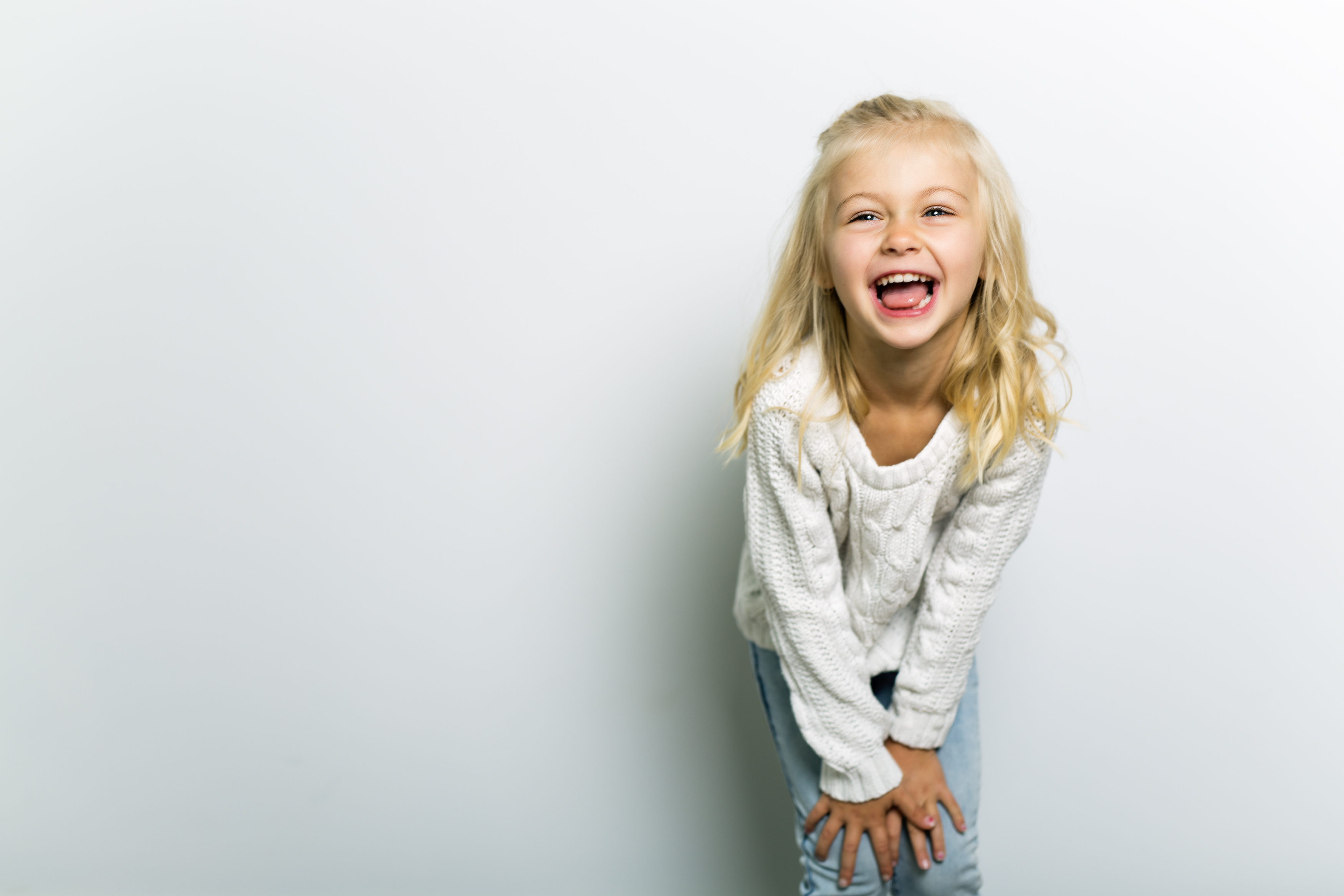 5-year-old-girl laughing at funny kids' jokes