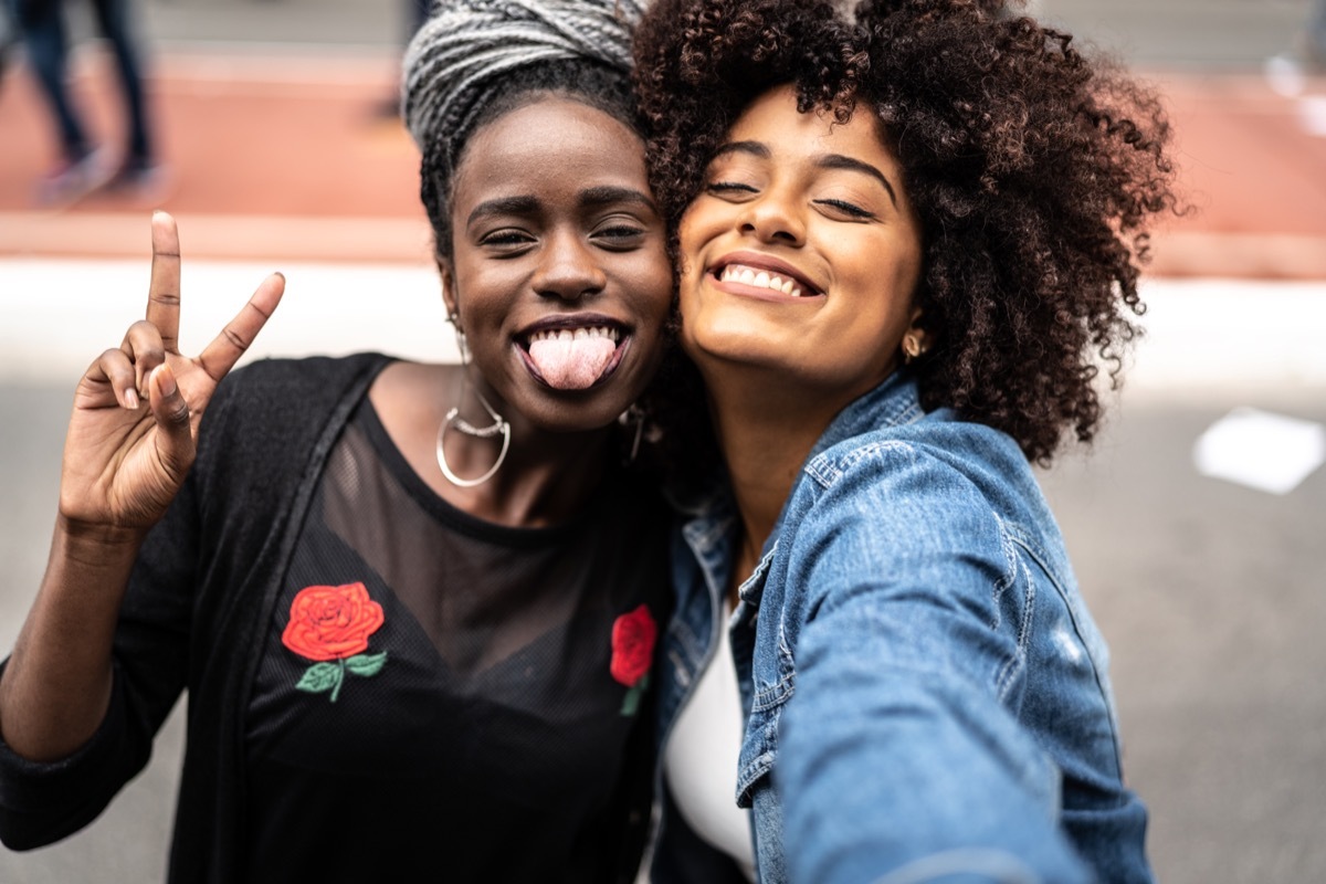 two girls posing and laughing for the camera