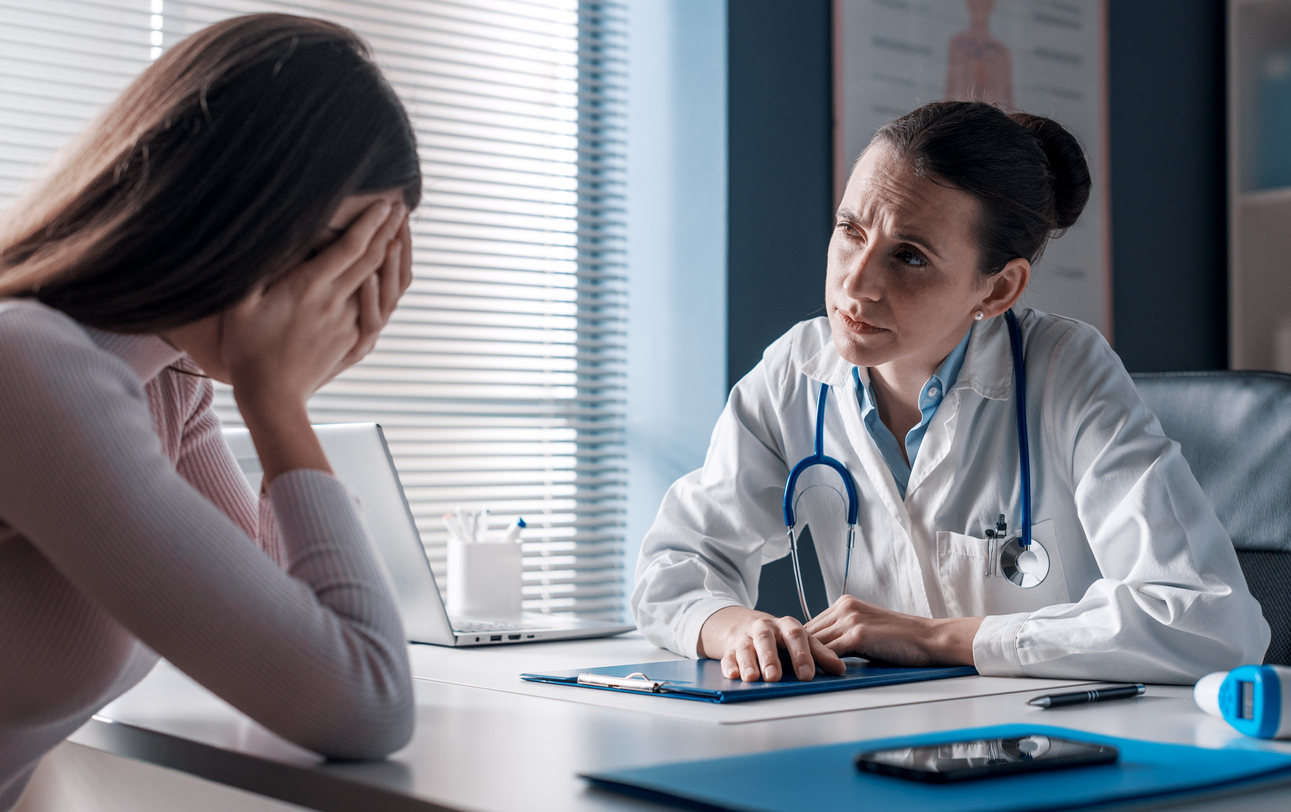 Doctor assisting a crying patient.