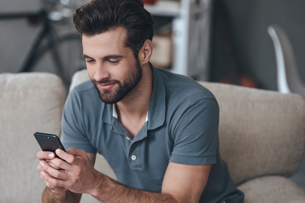 man smiling at his phone, should i be single