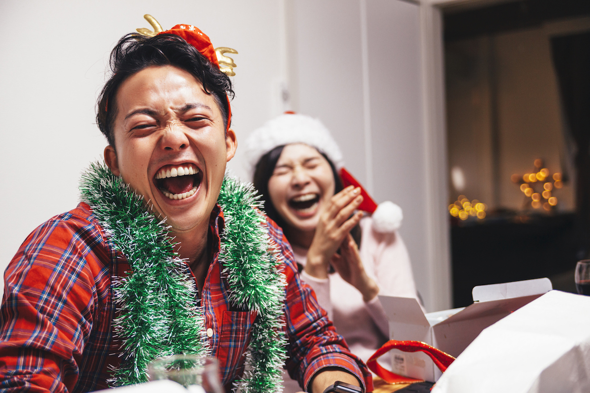 A happy young couple are sharing a good time with laughter on Christmas.