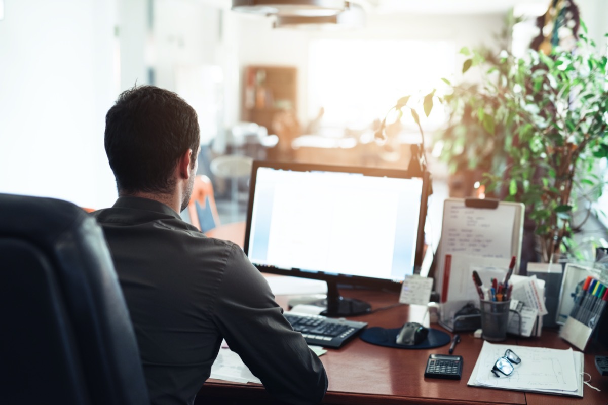 Businessman hard at work on a computer in an office