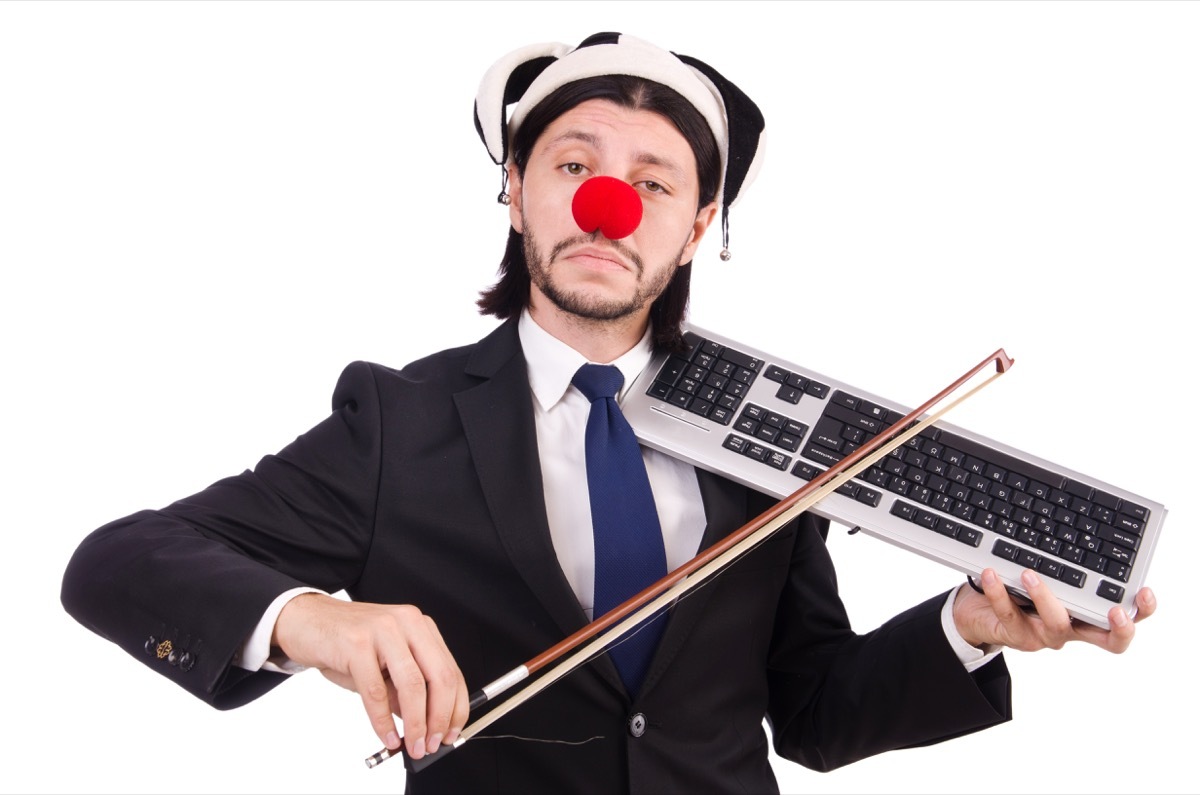 Man in a Clown Outfit Trying to Play a Keyboard Funny Stock Photos