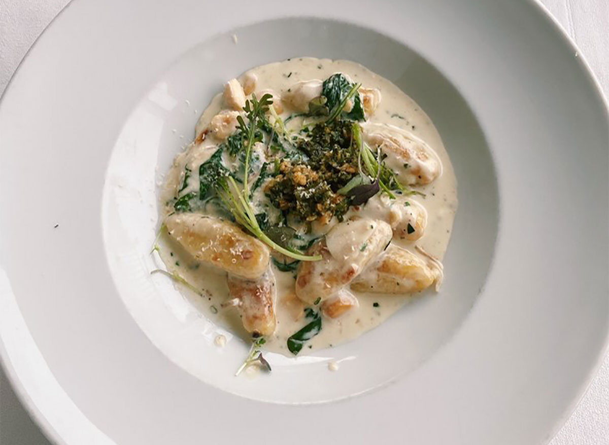 plate of gnocchi topped with broccolini