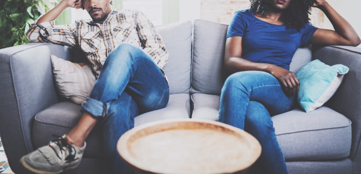 unhappy couple on couch