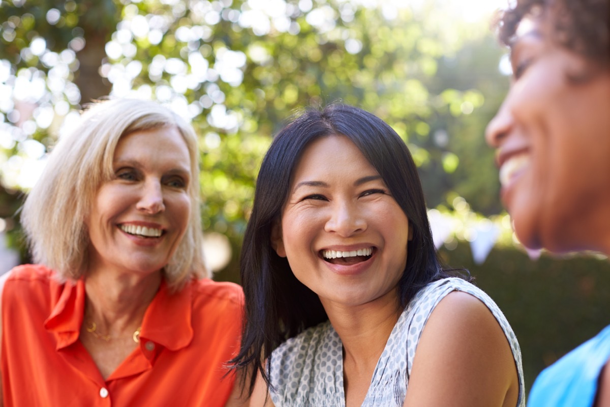 group of friends laughing, aging quicker