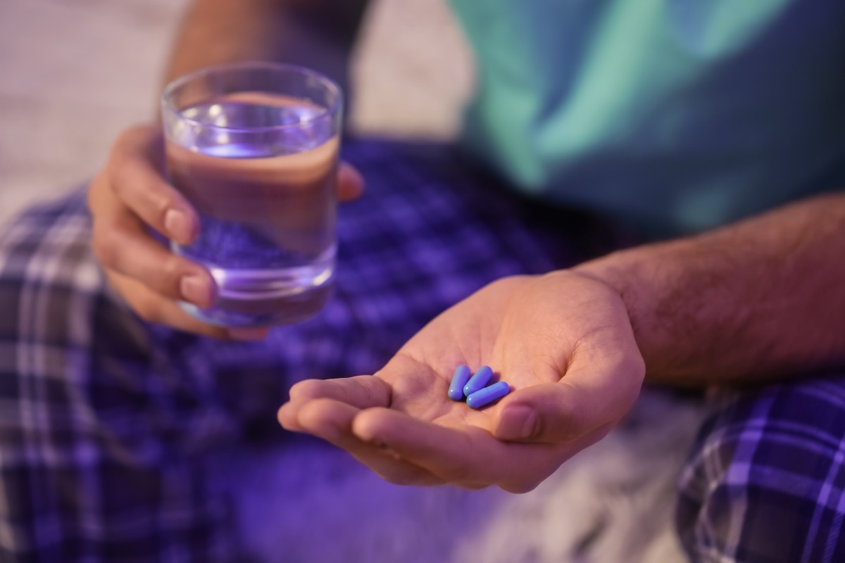 Hand Holding Three Pills