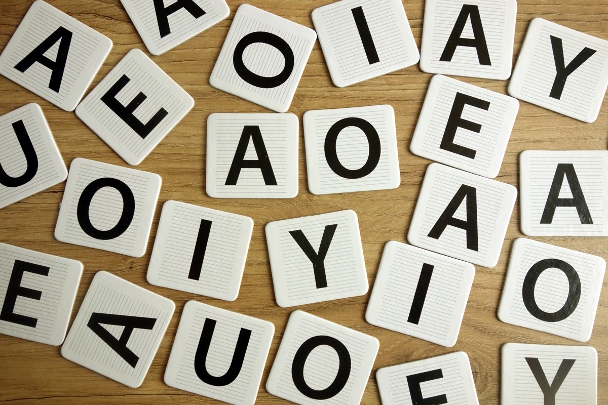 Vowel letters lying on desk, education concept