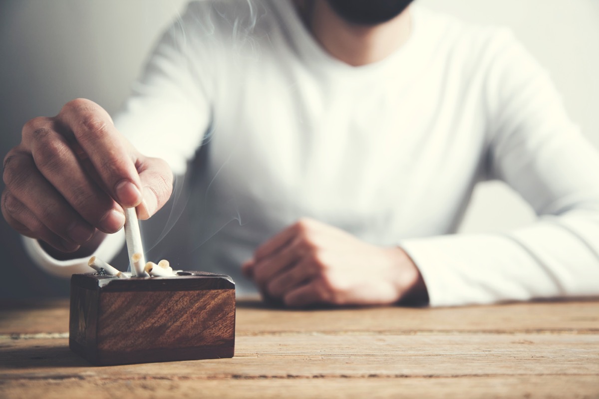 Man putting out cigarette