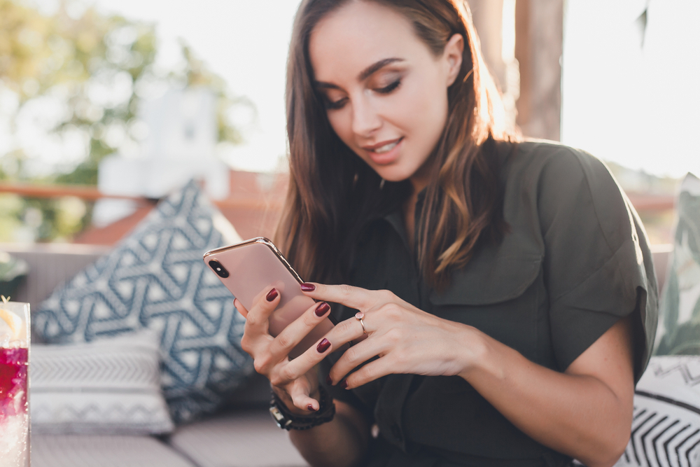 A young woman using her iPhone