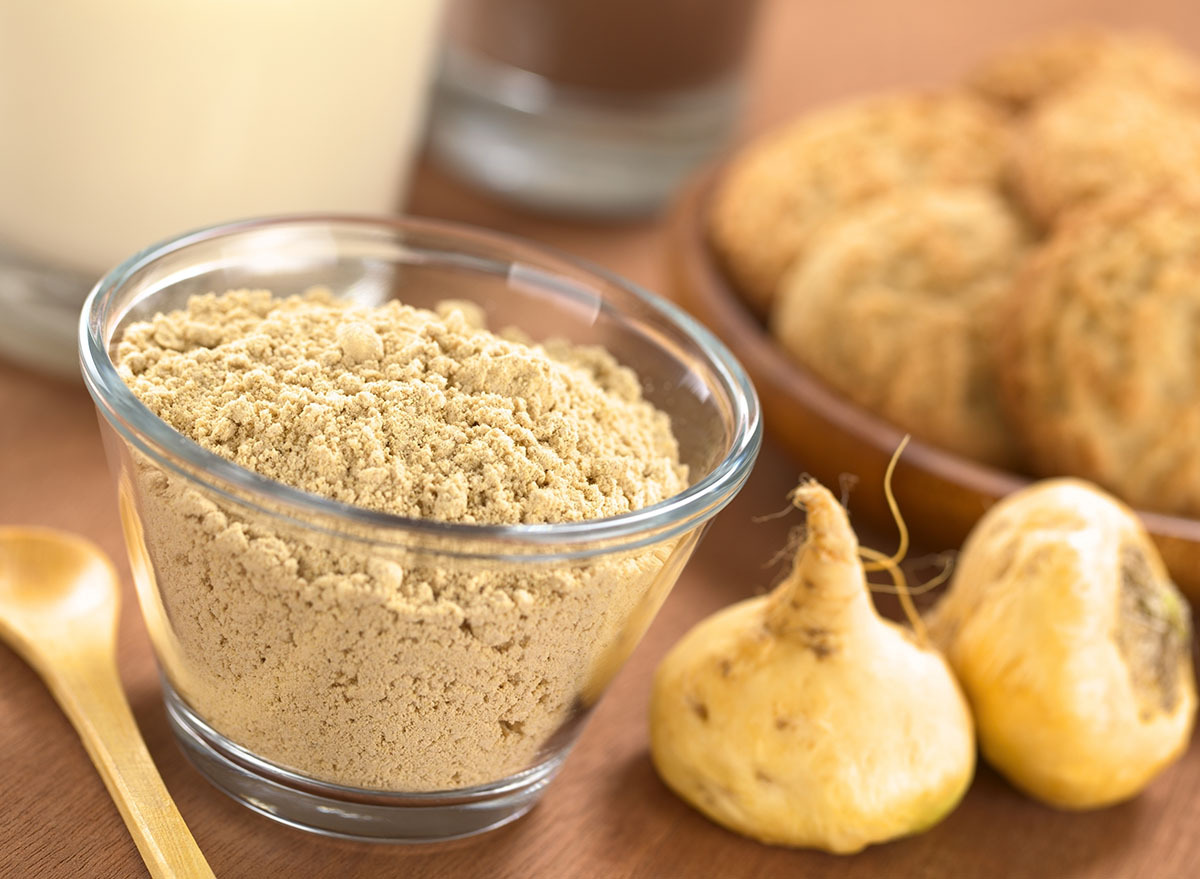 maca root and powder with wooden spoon