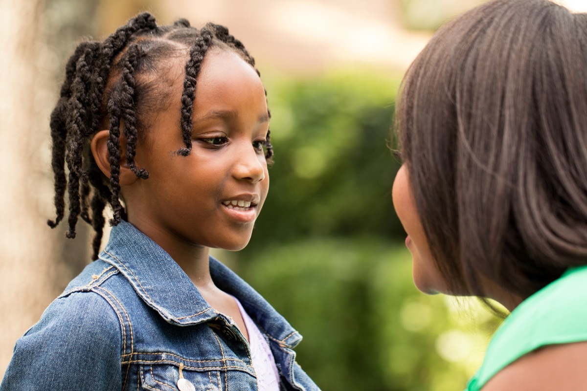 girl child talking to adult mom