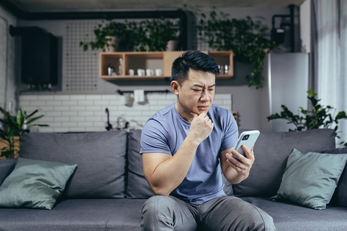 man looking concerned at cellphone