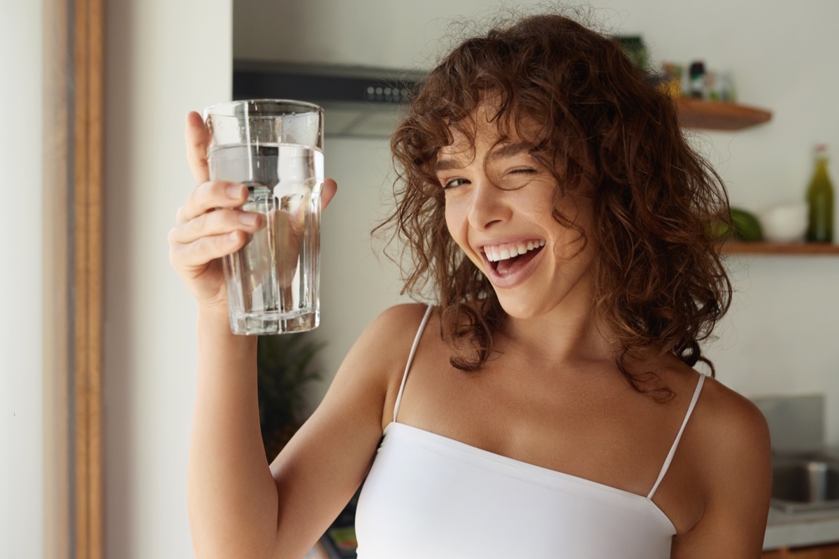 Happy Young Woman Drinking Water