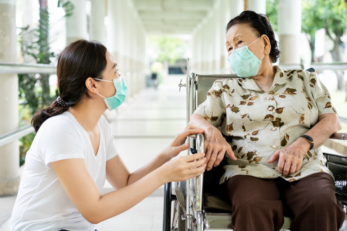 Older woman and daughter wearing masks