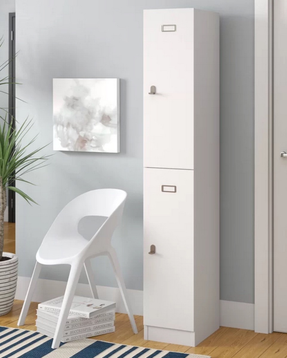 gray room with white lockers and chair