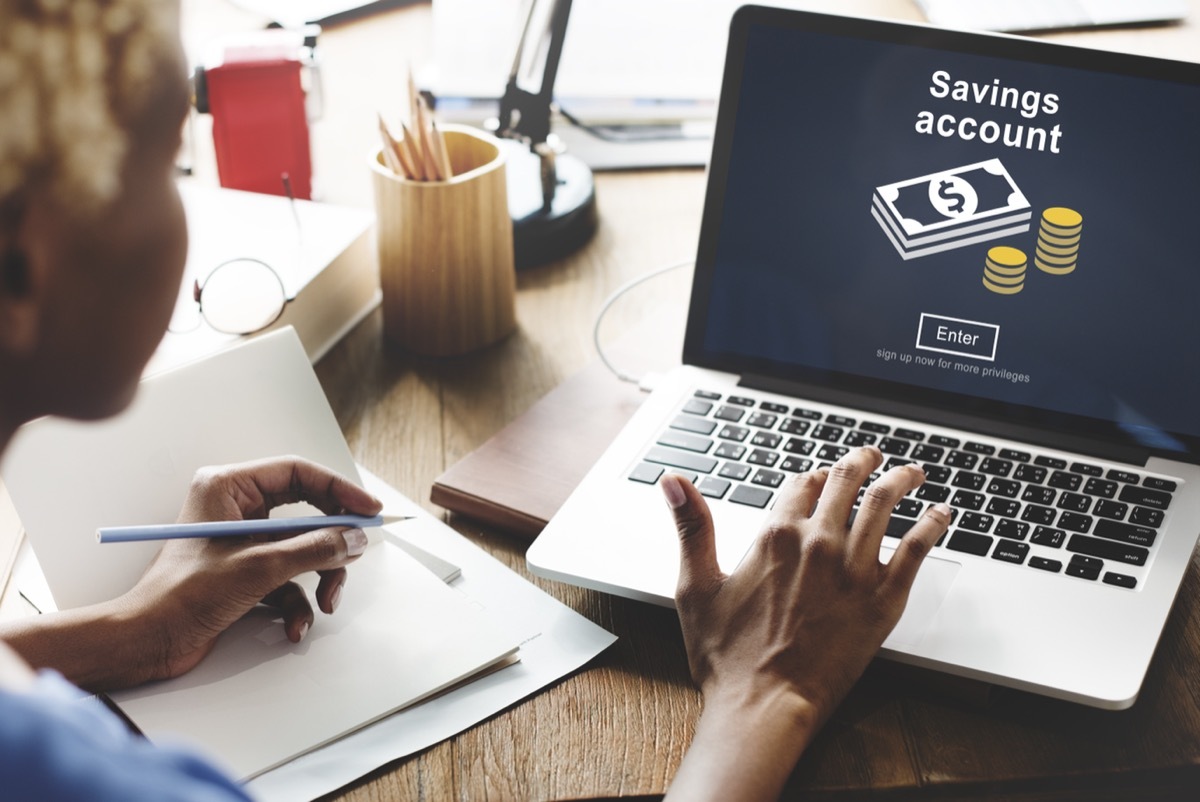 Woman looking at savings account on laptop