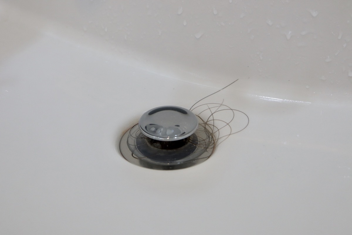 A few stray strands of hair fall on the sink.