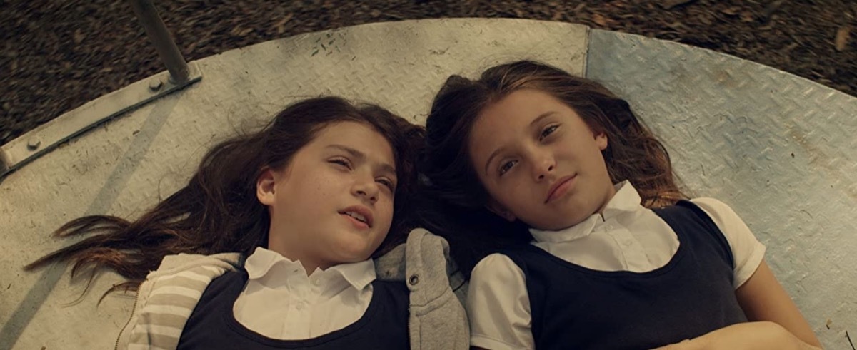 two young girls lying down in martys movie still