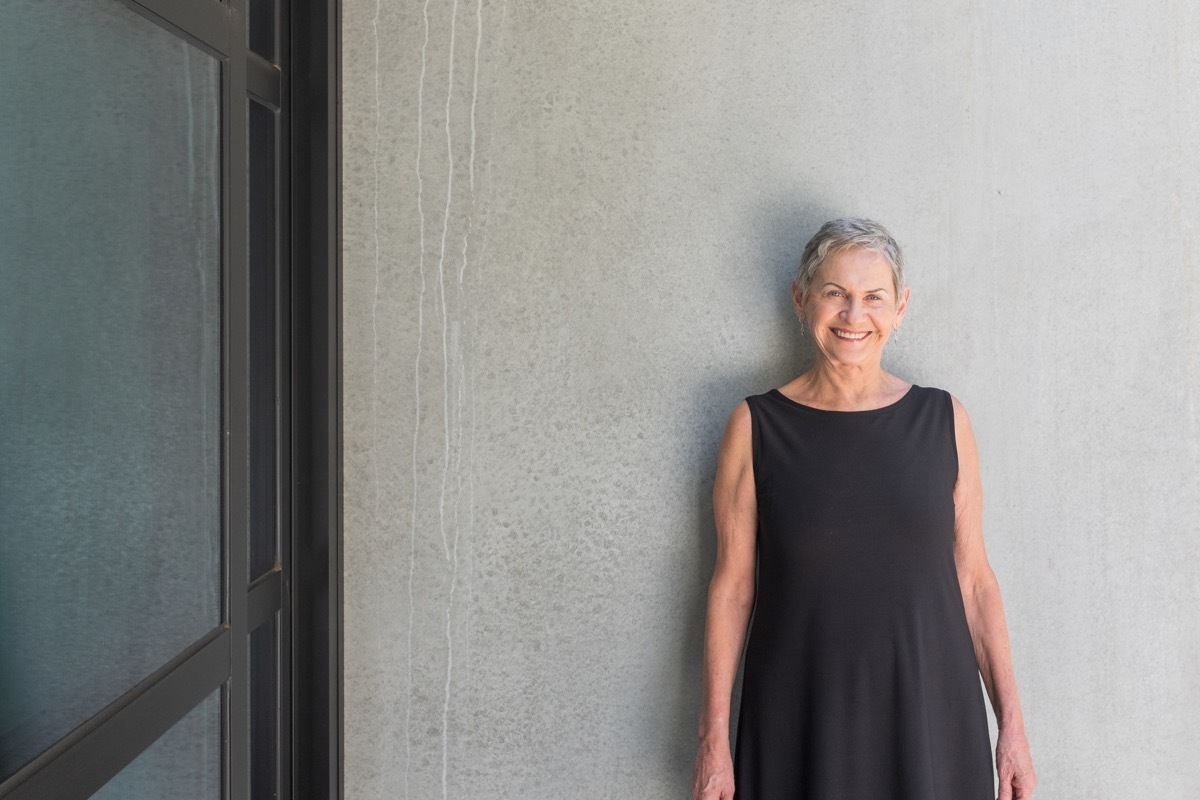 older woman sleeveless black dress