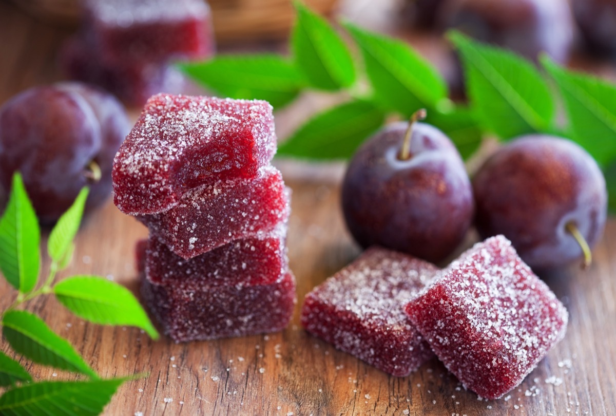 Six sugar plum candies lying on a wooden table