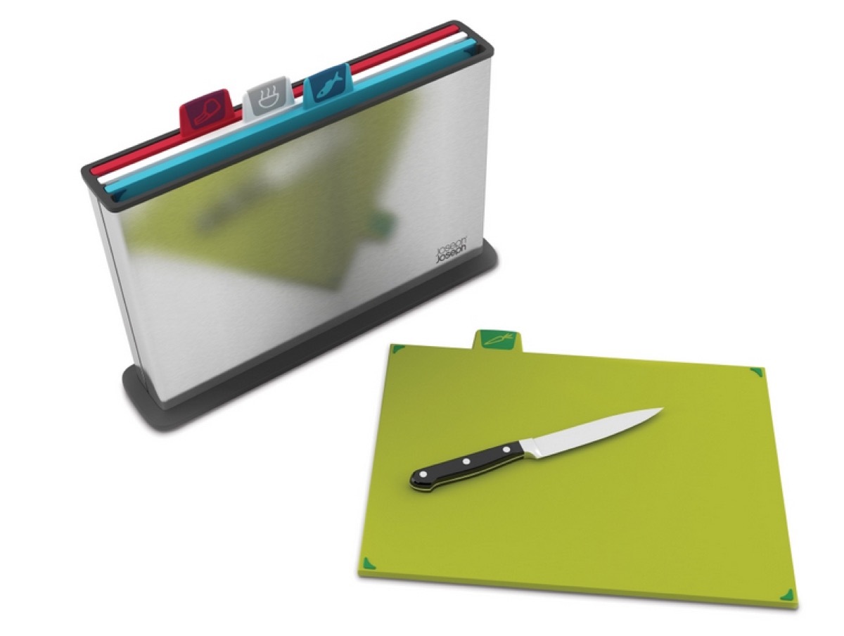 silver file folder with cutting board tabs and knife on green cutting board in front of it