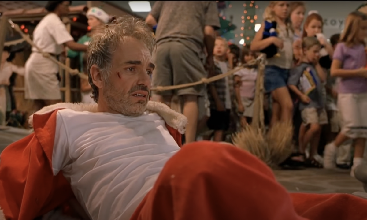 Bad Santa sits drunk in a mall.