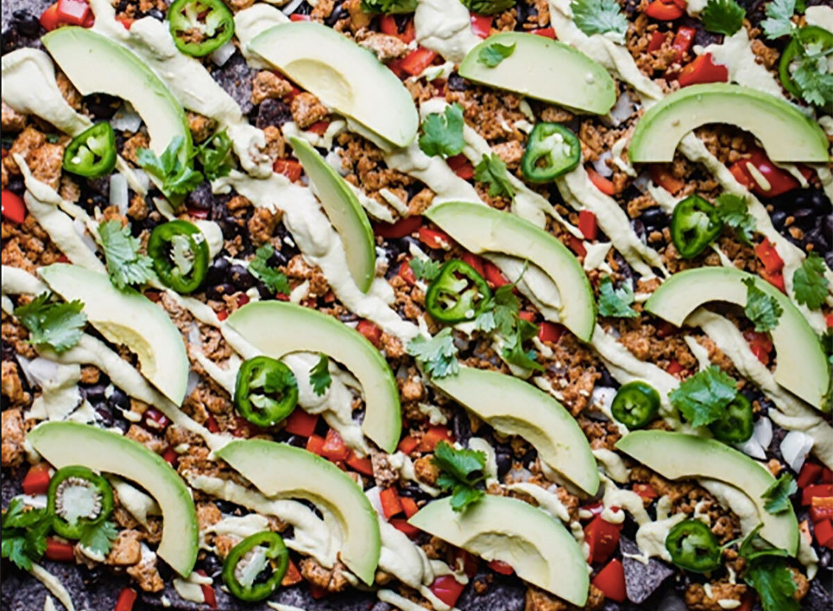 vegan nachos topped with avocado and jalapeno