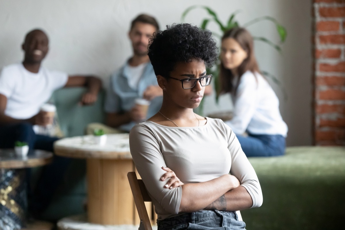 Woman feeling insulted by group of friends