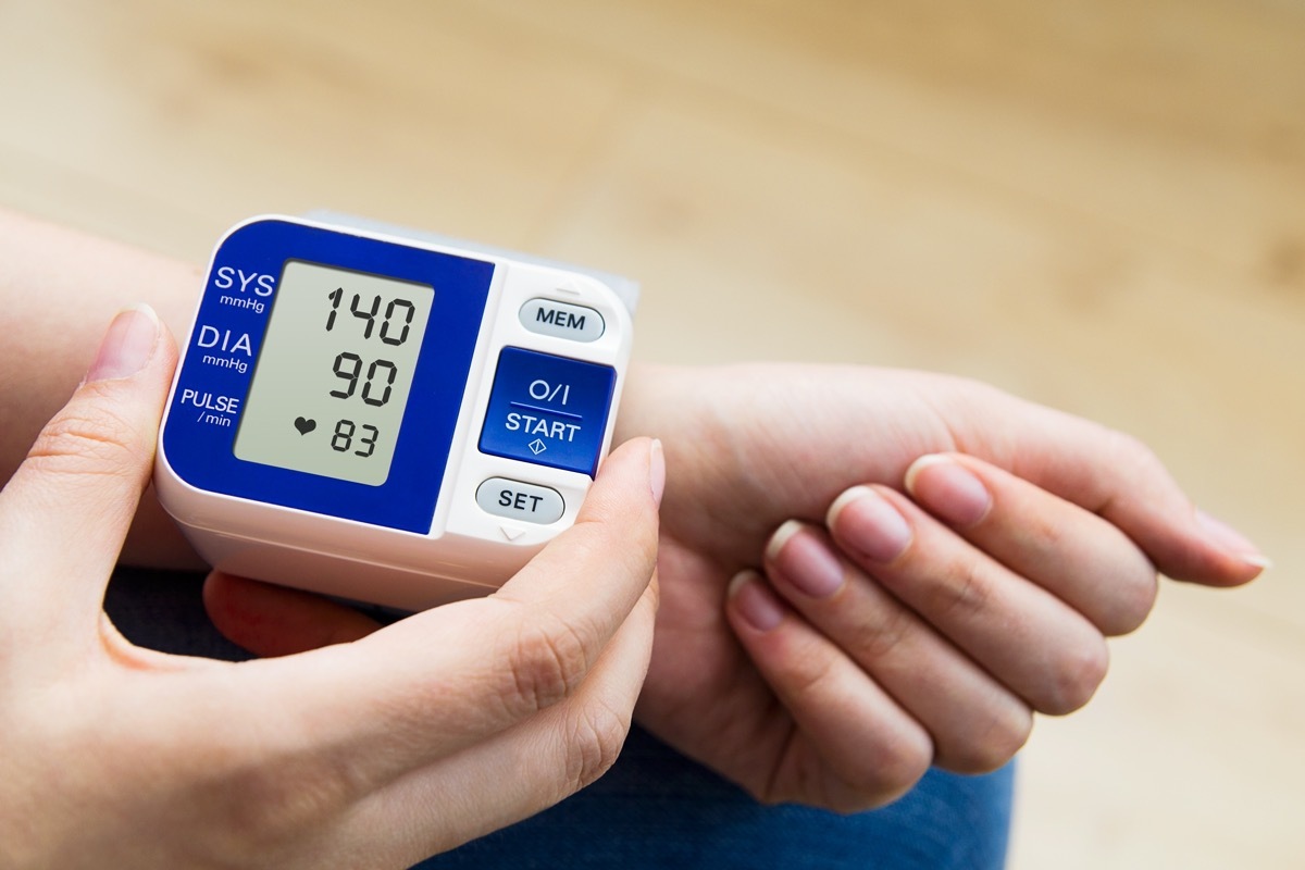 woman measures her blood pressure.