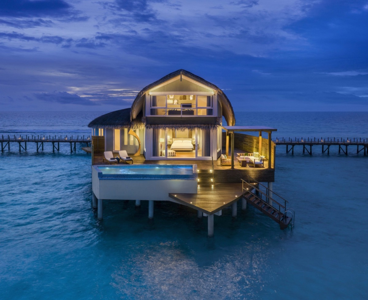 dusk view of an overwater bungalow at the JW Marriott Maldives Resort