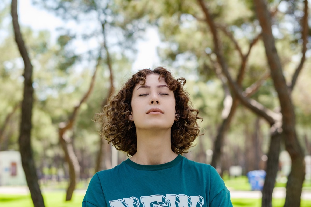 woman smelling the air