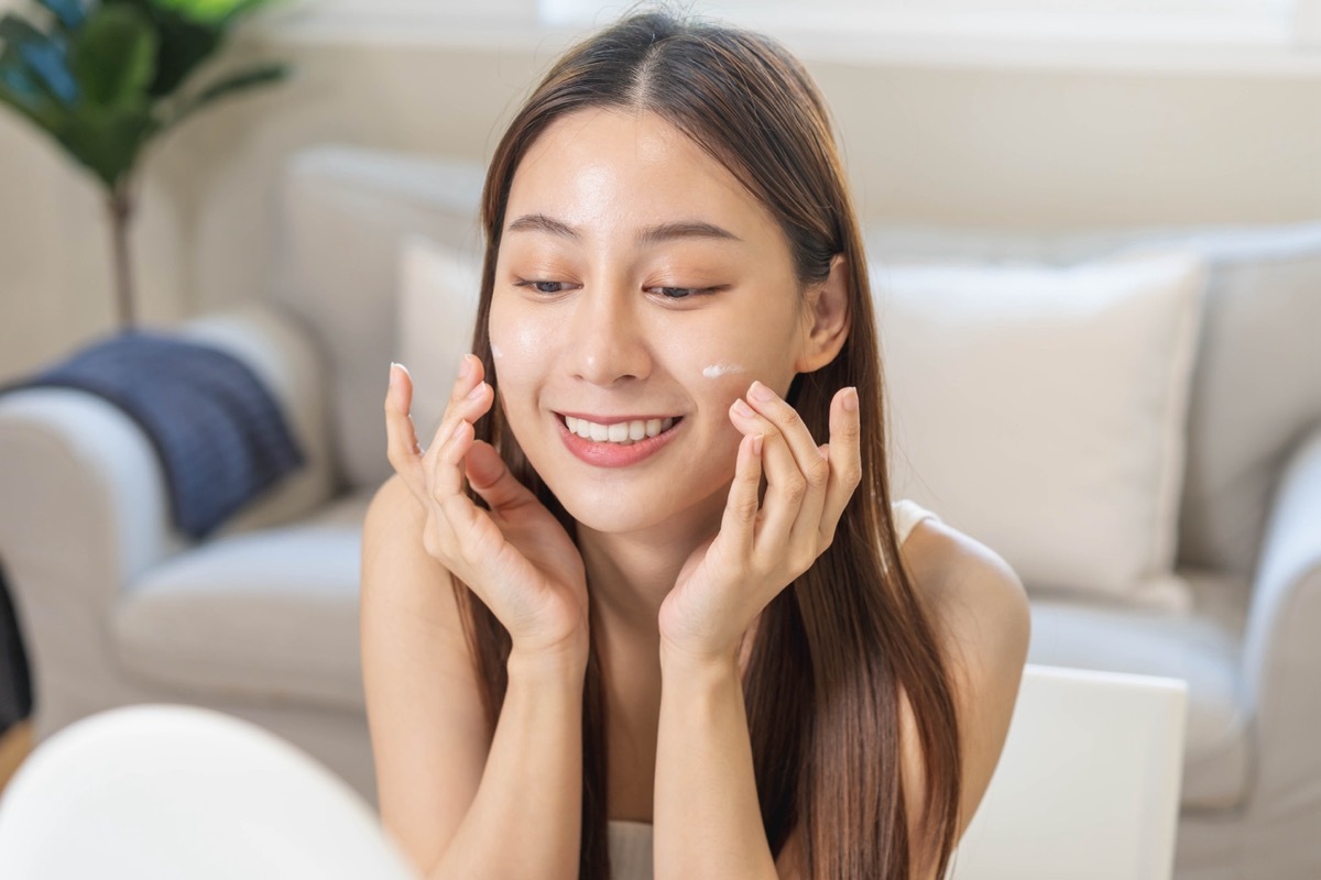 applying sunscreen to face