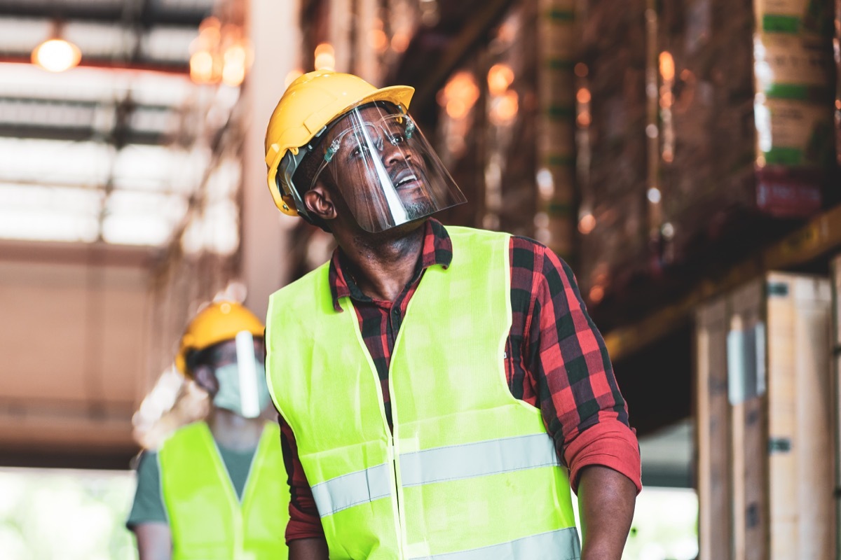 Construction worker wearing a face shield without a mask