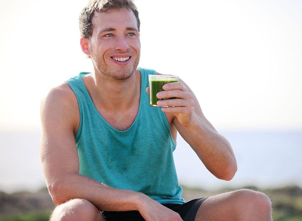 man drinking green smoothie